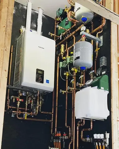 Showpiece hydronic boiler room installed by Burt's Breeze with immaculate copper manifold work