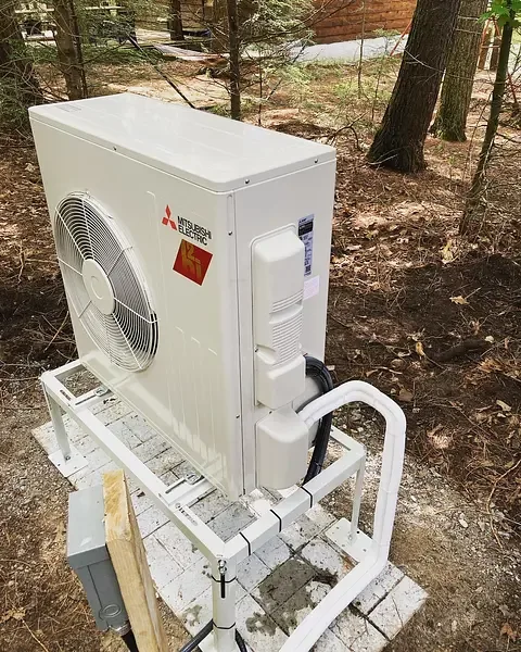Ductless heat pump outdoor unit installed on a stand by Burt’s Breeze