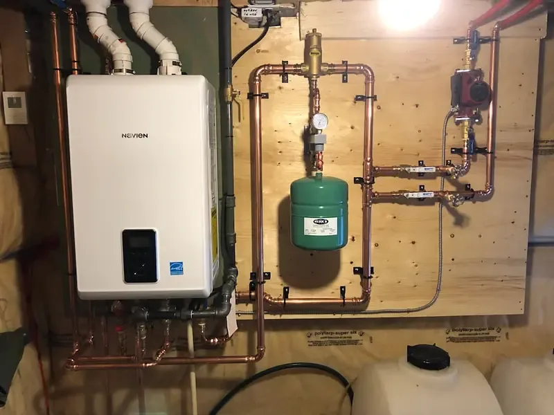 Wall-mounted tankless water heater installed by Burt’s Breeze